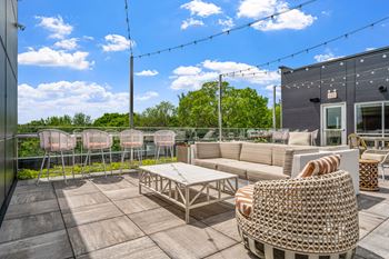 a patio with a couch and chairs and a coffee table